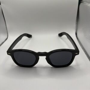 Black round frame sunglasses with dark tinted lenses